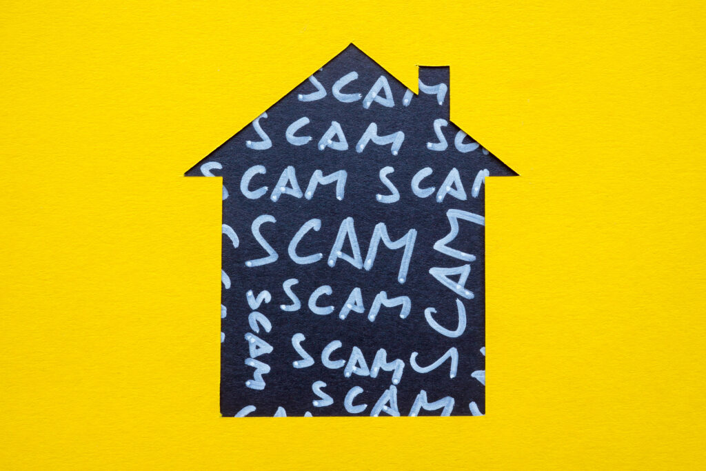 House outline as a real estate concept and the words scam.